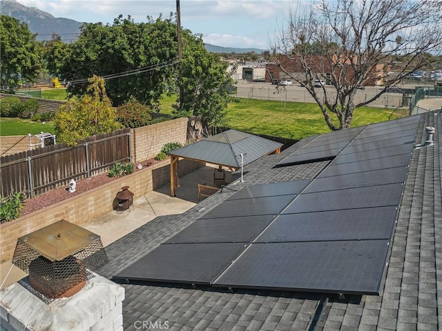 view of swimming pool with a fenced backyard, a mountain view, and a yard