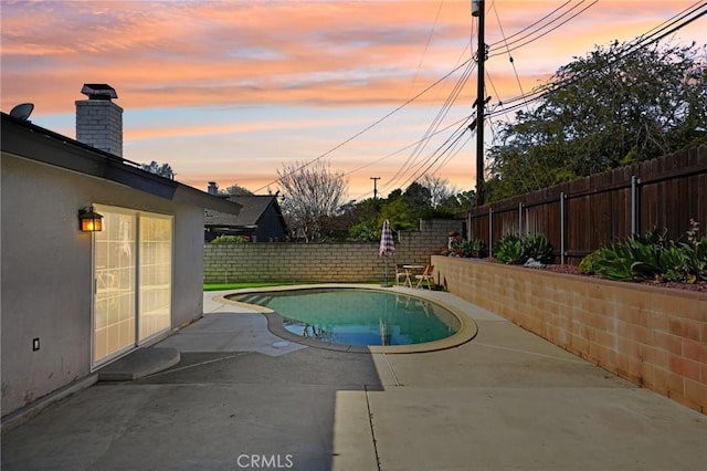 view of swimming pool featuring a fenced backyard, a fenced in pool, and a patio