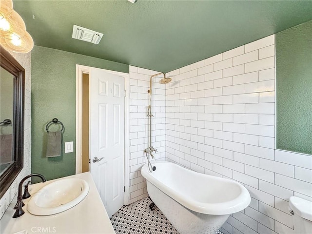 full bathroom featuring a soaking tub, visible vents, tile walls, and walk in shower