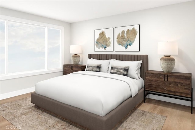 bedroom featuring light wood-type flooring and baseboards