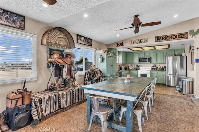 dining area with light carpet, a ceiling fan, vaulted ceiling, a textured ceiling, and recessed lighting