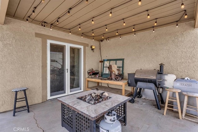 view of patio / terrace with a fire pit and french doors