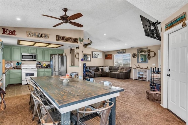 dining area with lofted ceiling, light carpet, and a textured ceiling