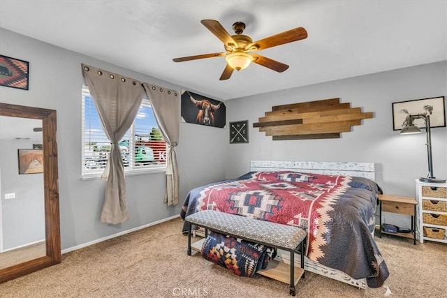 bedroom featuring a ceiling fan, light carpet, and baseboards