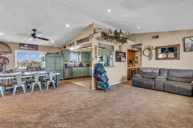 living area with a textured ceiling, recessed lighting, light colored carpet, visible vents, and vaulted ceiling