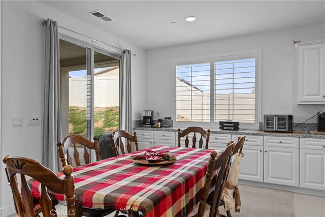 dining room featuring recessed lighting, visible vents, and a toaster