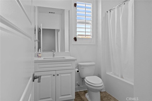 bathroom with visible vents, toilet, shower / tub combo, and vanity