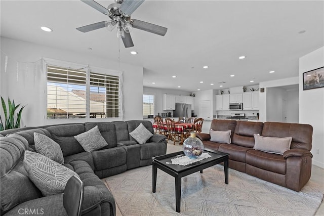 living area with ceiling fan and recessed lighting