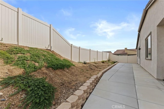 view of yard with a fenced backyard and a patio area