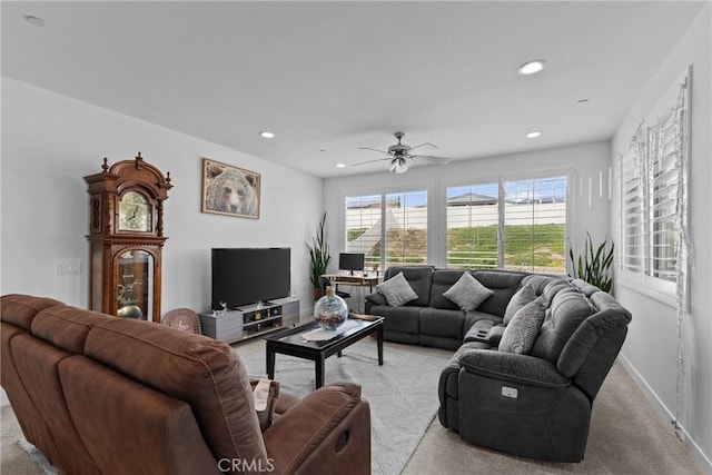 living room featuring light carpet, ceiling fan, baseboards, and recessed lighting