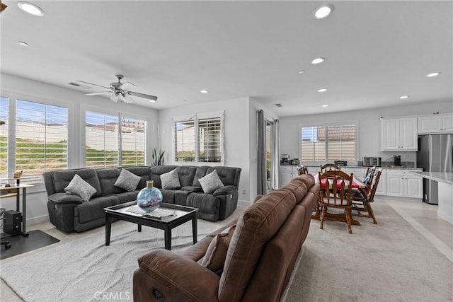 living room featuring baseboards, ceiling fan, and recessed lighting