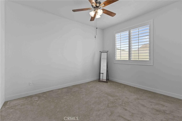 unfurnished room featuring baseboards, carpet floors, and ceiling fan