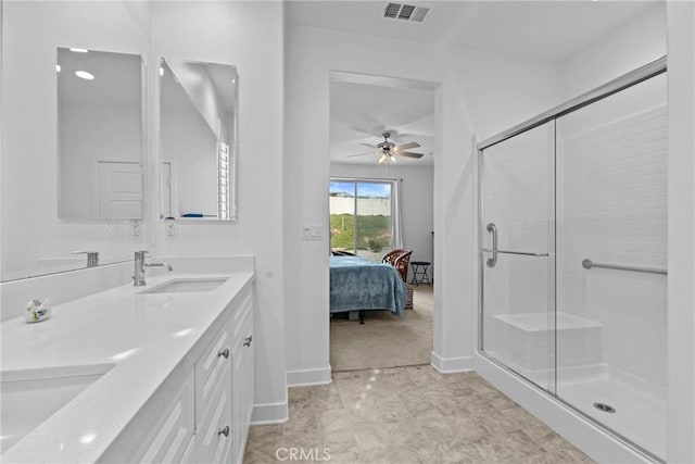 ensuite bathroom with visible vents, double vanity, ceiling fan, a sink, and a stall shower