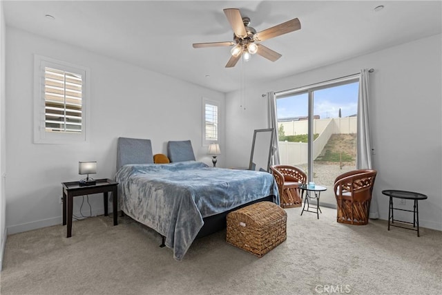 bedroom with baseboards, carpet flooring, and a ceiling fan