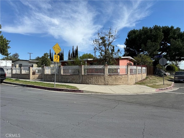 community / neighborhood sign with fence