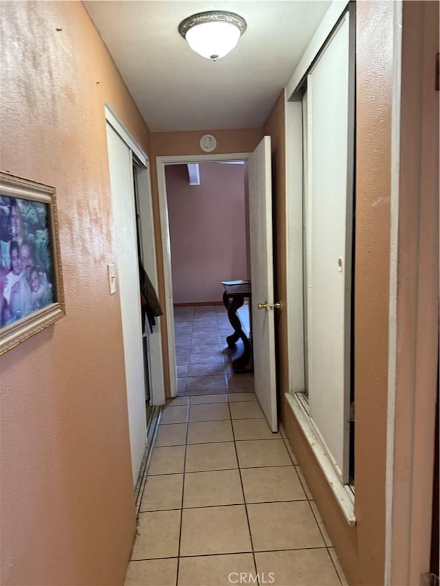 hall with light tile patterned flooring