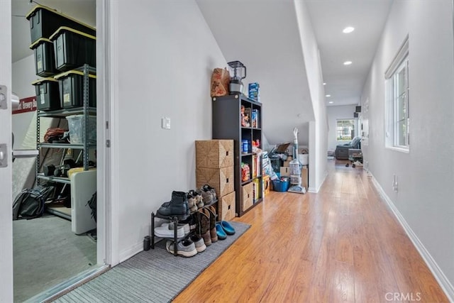 hall with baseboards, wood finished floors, and recessed lighting