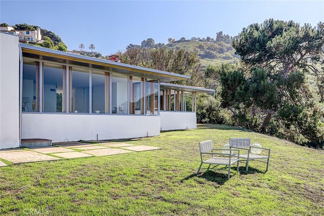 view of yard featuring a sunroom