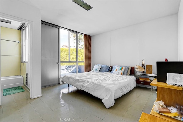 bedroom with access to exterior, visible vents, and light tile patterned floors