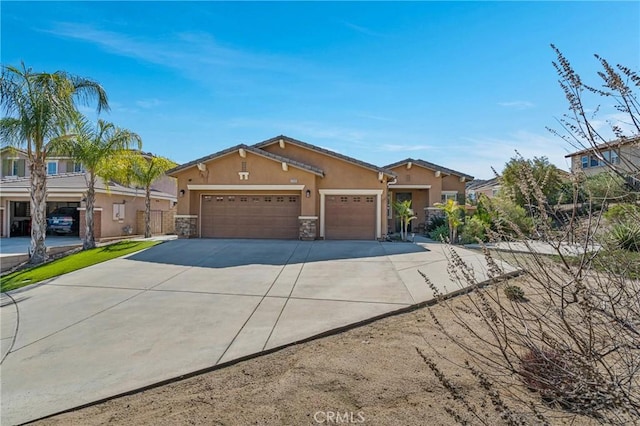 view of front of house with a garage, stone siding, concrete driveway, and stucco siding