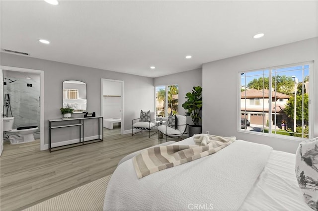 bedroom with recessed lighting, visible vents, light wood-style flooring, connected bathroom, and baseboards