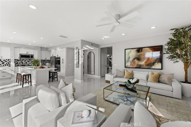 living room featuring visible vents, a ceiling fan, and recessed lighting