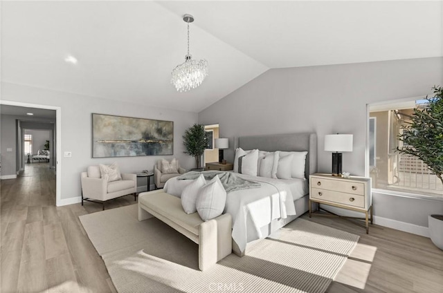 bedroom with lofted ceiling, light wood-type flooring, baseboards, and a notable chandelier