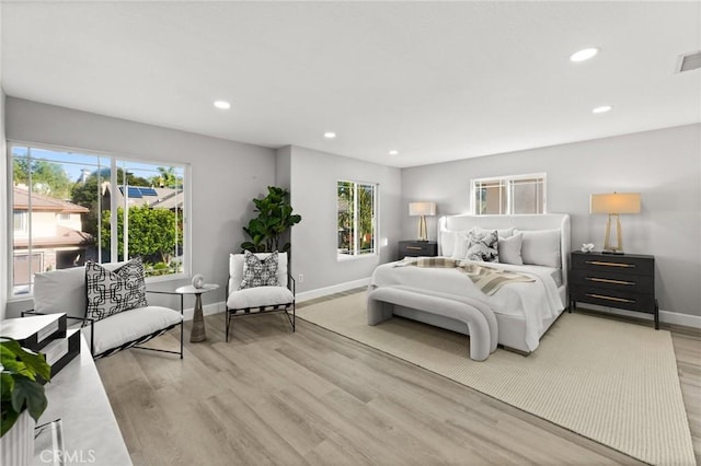 bedroom with baseboards, visible vents, light wood-style flooring, and recessed lighting