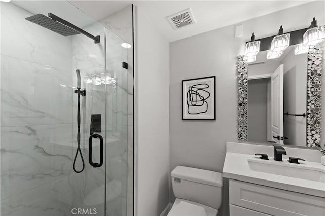 full bathroom with a marble finish shower, visible vents, vanity, and toilet