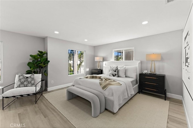 bedroom with recessed lighting, light wood-style flooring, and baseboards