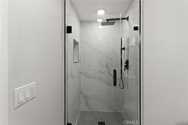 bathroom with a marble finish shower