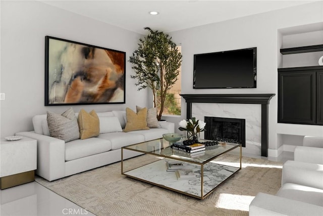 living room with recessed lighting and a high end fireplace