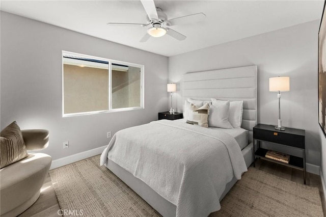 bedroom with a ceiling fan and baseboards