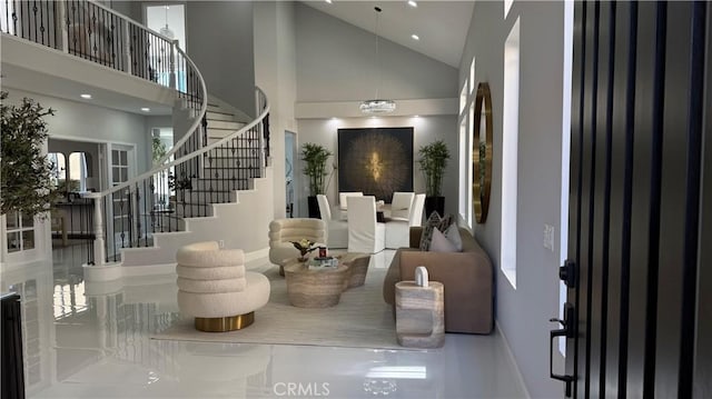 foyer entrance featuring stairs, high vaulted ceiling, and recessed lighting