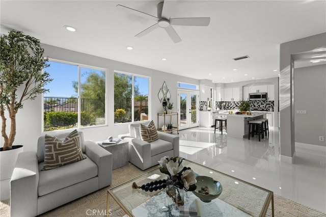 living room featuring baseboards, visible vents, ceiling fan, french doors, and recessed lighting