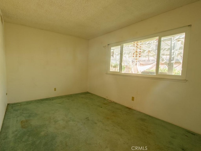 unfurnished room featuring light carpet and a textured ceiling