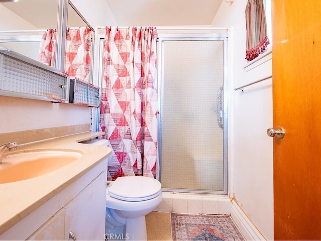 bathroom with toilet, a stall shower, and vanity