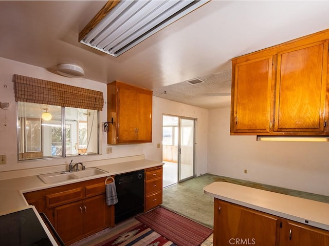 kitchen with a sink, visible vents, light countertops, dishwasher, and brown cabinetry