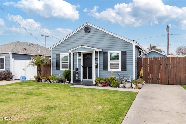 view of front of house with a gate, fence, and a front lawn