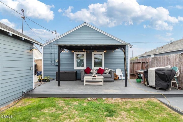 back of house with an outdoor hangout area, a yard, fence, and a wooden deck