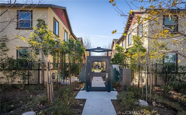 doorway to property with fence and stucco siding