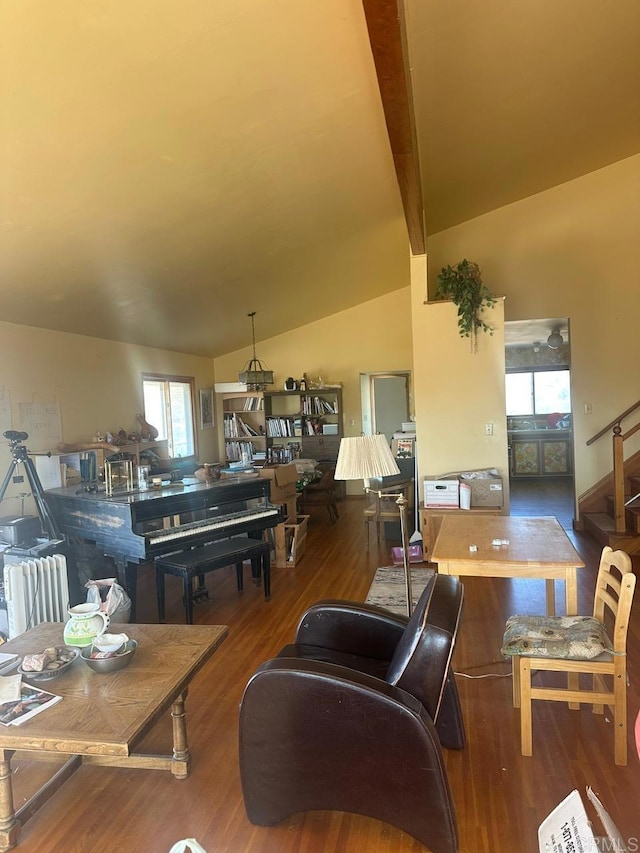 living room with lofted ceiling with beams, stairway, and wood finished floors