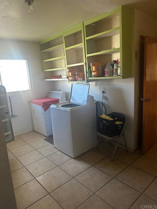 laundry area featuring light tile patterned floors, laundry area, and independent washer and dryer