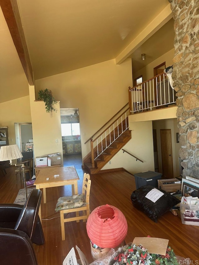 living room with high vaulted ceiling, beamed ceiling, stairway, and wood finished floors