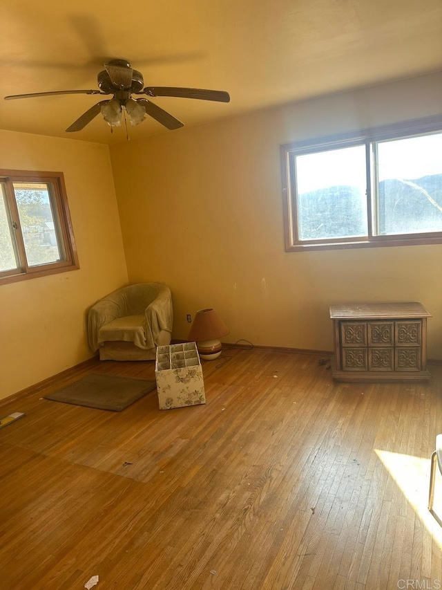 unfurnished room featuring visible vents, baseboards, and wood finished floors