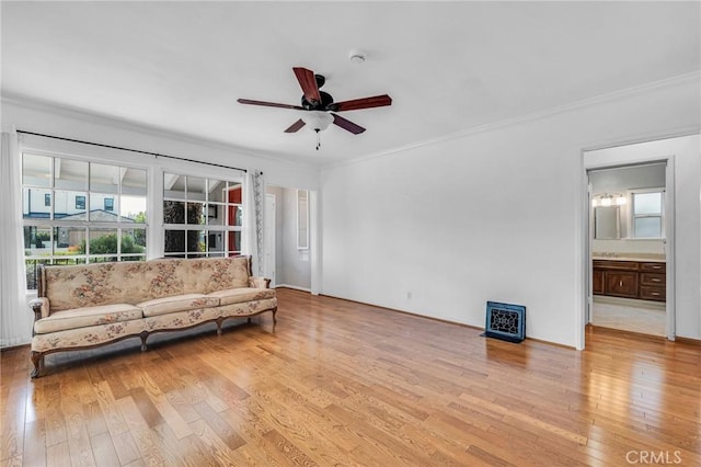 living area featuring ornamental molding, a ceiling fan, and light wood-style floors