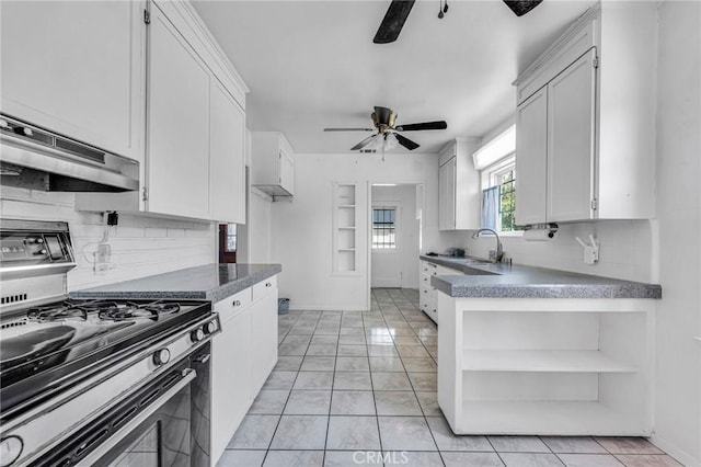 kitchen featuring white cabinetry, ceiling fan, decorative backsplash, and gas range