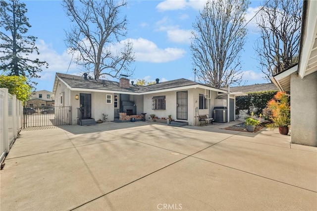 back of house featuring entry steps, a patio, cooling unit, and stucco siding