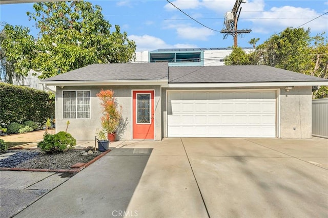 ranch-style house with a garage, driveway, a shingled roof, and stucco siding