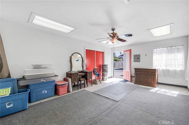 misc room with a ceiling fan and electric panel